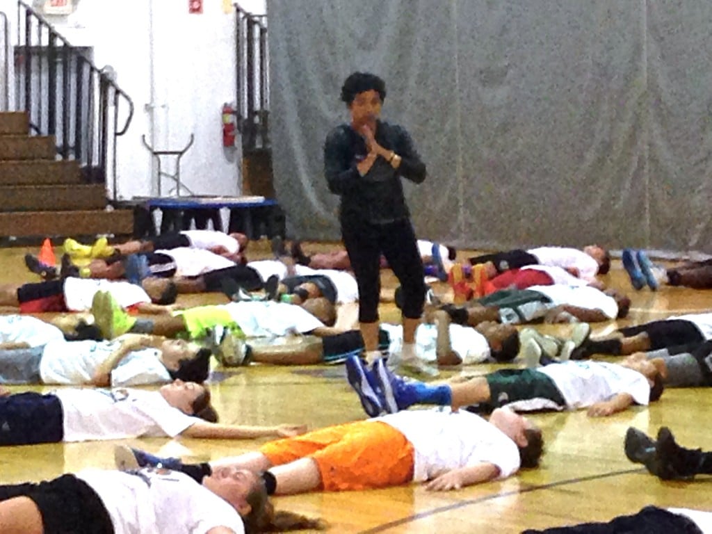 Players in savasana at the Mateen Cleaves 1 Goal 1 Passion Basketball Camp in Lansing.